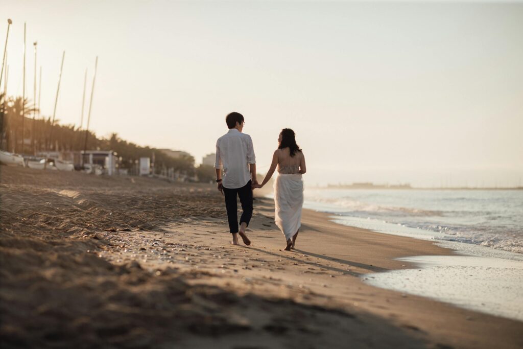 Back View of a Couple Walking on the Beach in Spain