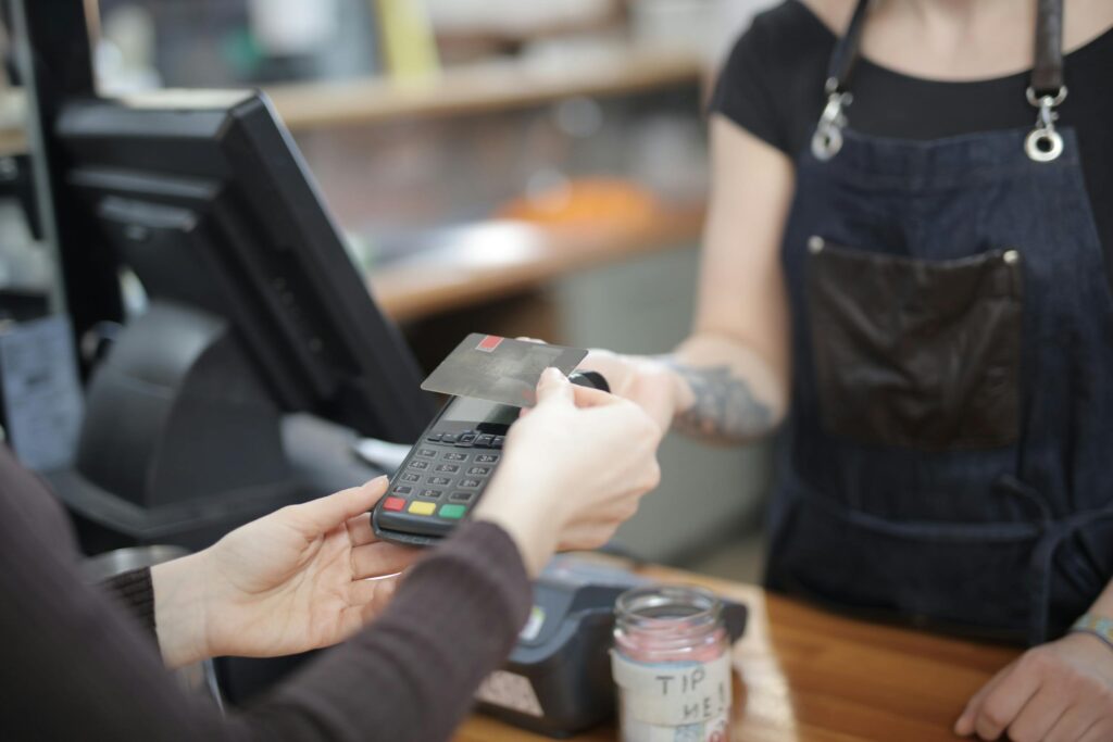 Person Holding Credit Card giving a tip
