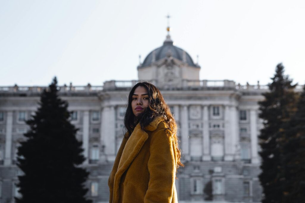 Woman Standing in Front of White Building